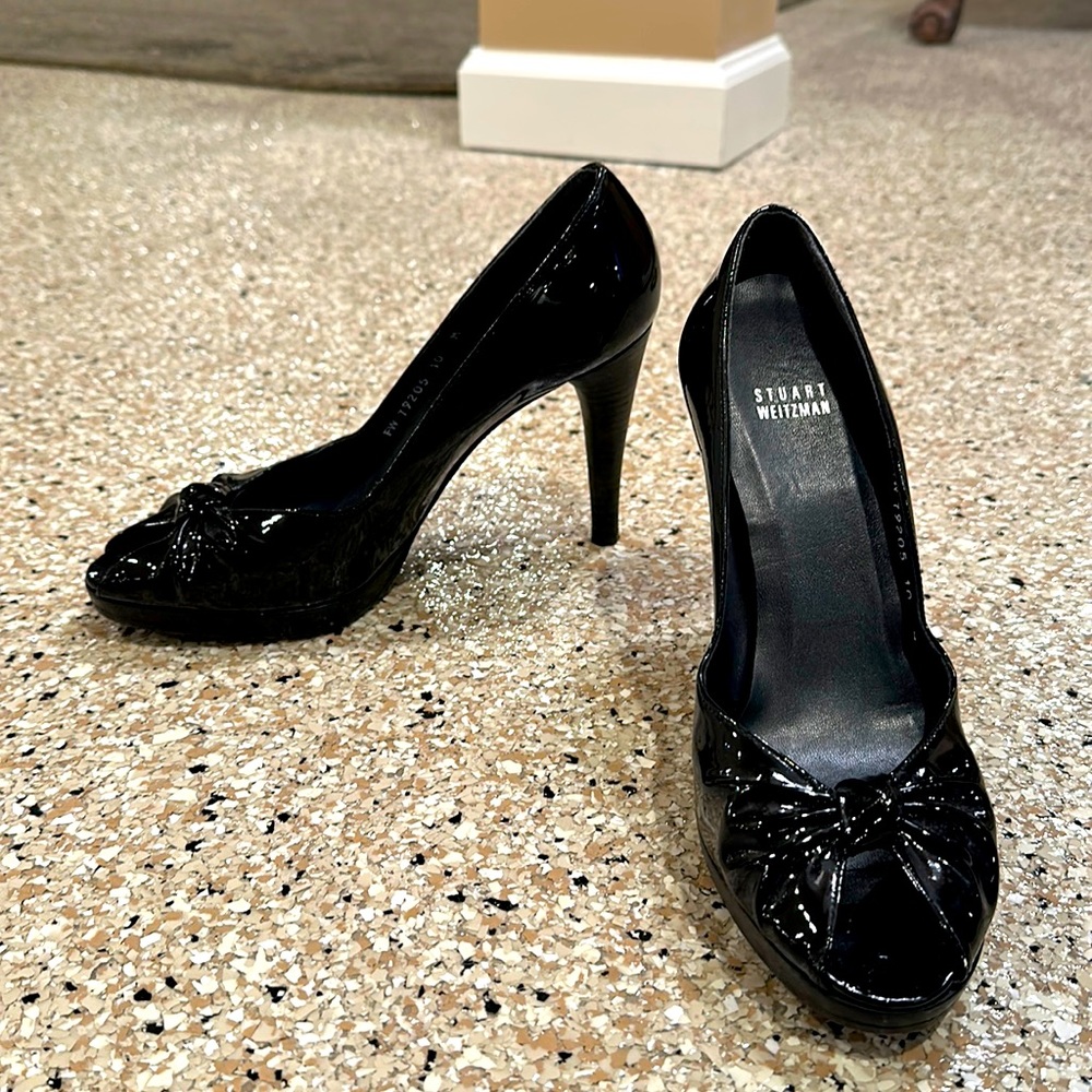 Stuart Weitzman black patent leather peep toe pumps. 4 inch heels.